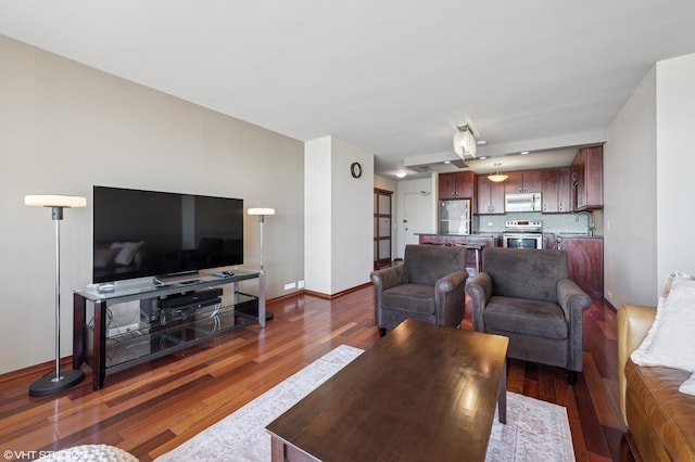 living room featuring wood finished floors and baseboards