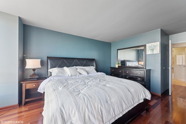 bedroom with baseboards and wood finished floors