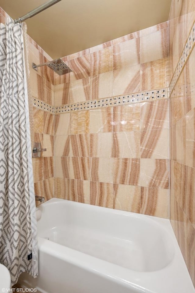 bathroom with shower / bath combination with curtain