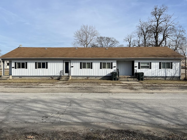 view of front of home with a shingled roof and board and batten siding