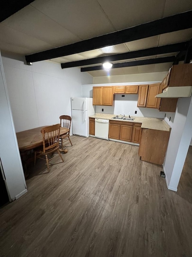 kitchen with light countertops, brown cabinetry, a sink, wood finished floors, and white appliances