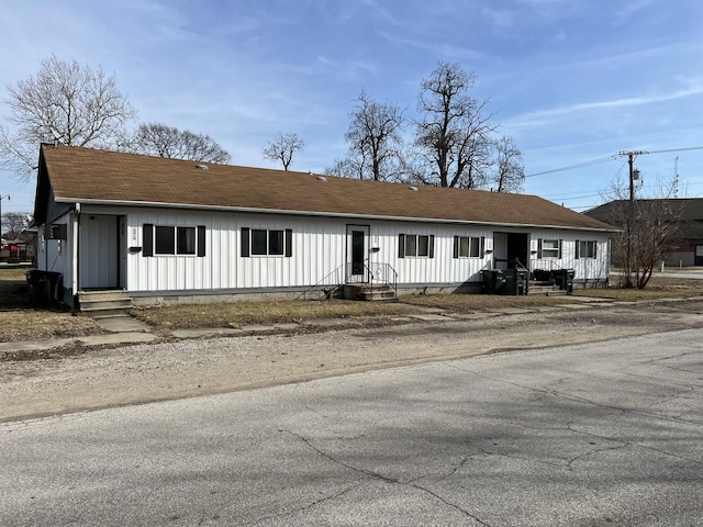 ranch-style home with crawl space, board and batten siding, and a shingled roof