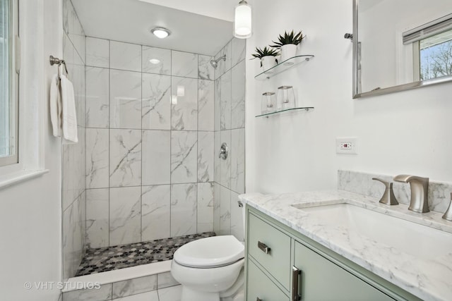 full bathroom with toilet, a shower stall, and vanity