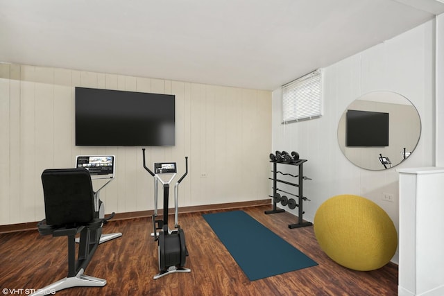 workout room with baseboards and dark wood-style flooring