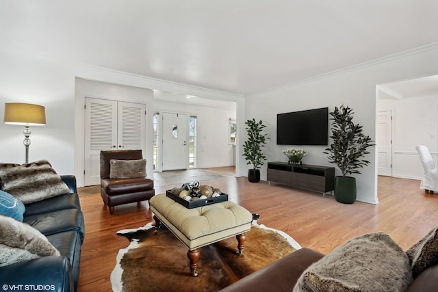 living room featuring crown molding and wood finished floors