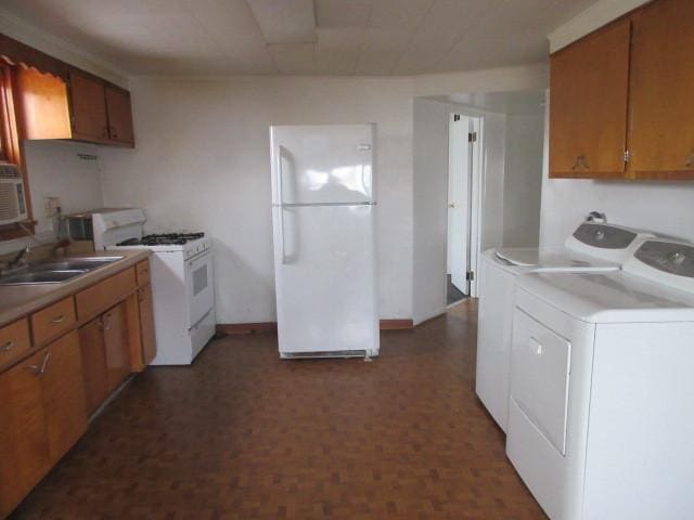 525 Price Ave, Calumet City, IL 60409 - kitchen with white appliances, washer and clothes dryer, a sink, and light countertops