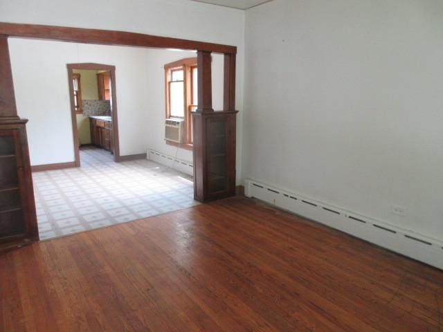 empty room with a baseboard heating unit and light wood-type flooring