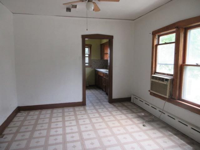 525 Price Ave, Calumet City, IL 60409 - spare room with light floors, a ceiling fan, a baseboard heating unit, and a wealth of natural light