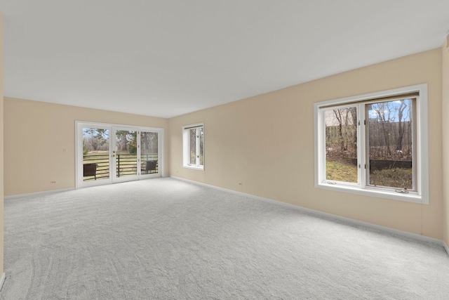 carpeted spare room with baseboards