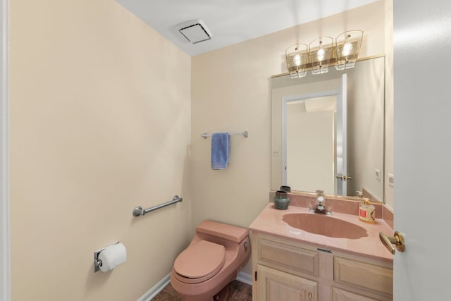 half bathroom featuring toilet and vanity