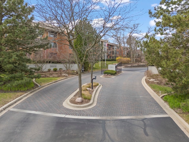 view of street featuring curbs and a gated entry