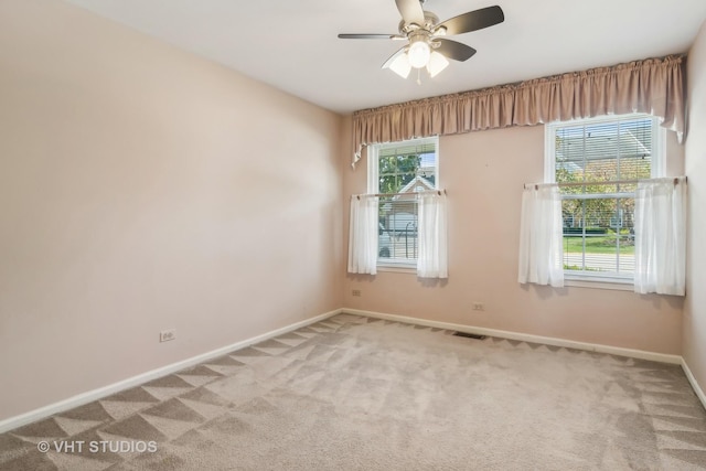 empty room featuring a ceiling fan, baseboards, and carpet flooring