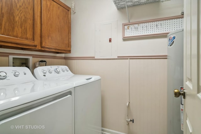 laundry room featuring wainscoting, independent washer and dryer, cabinet space, and electric panel