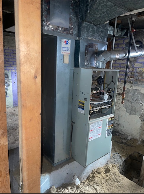 utility room featuring heating unit