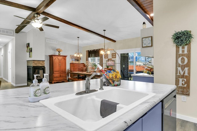 kitchen with visible vents, vaulted ceiling with beams, a sink, light countertops, and dishwasher