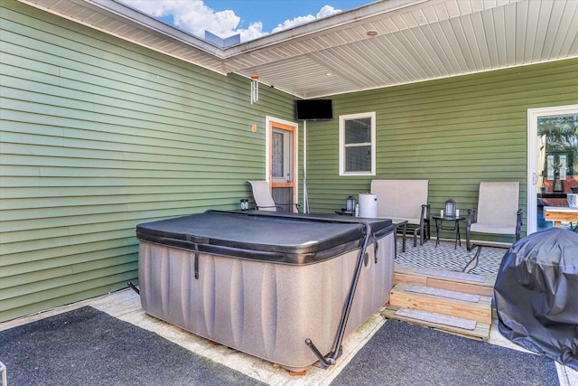 view of patio / terrace with a hot tub