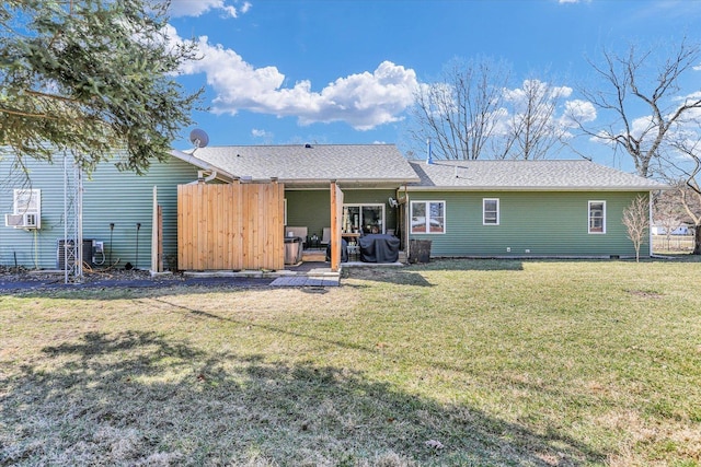 rear view of house with cooling unit, a patio, a lawn, and fence