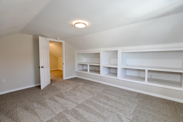 bonus room with vaulted ceiling, carpet floors, baseboards, and built in features