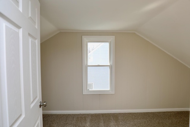 additional living space with carpet floors, vaulted ceiling, and baseboards