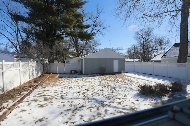 snowy yard featuring a fenced backyard