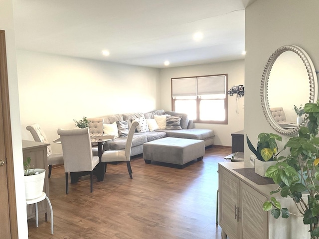 living room with dark wood-style floors and recessed lighting