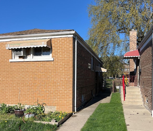 view of side of property with brick siding