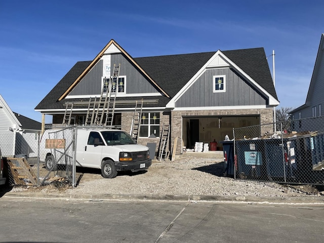 view of front facade featuring brick siding and roof with shingles