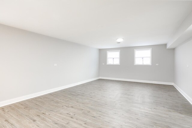 spare room featuring wood finished floors and baseboards