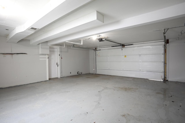 garage with visible vents and a garage door opener