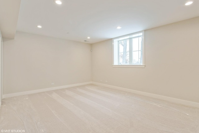 basement with light carpet, baseboards, and recessed lighting