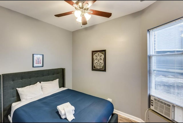 bedroom featuring ceiling fan and baseboards