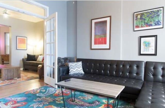 living area with french doors and wood finished floors