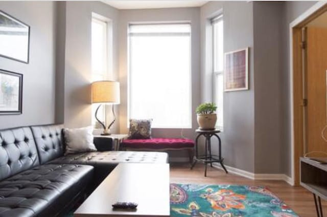 living room with light wood-type flooring and baseboards