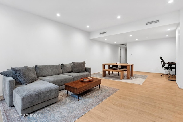 living area featuring light wood-style flooring, visible vents, and recessed lighting