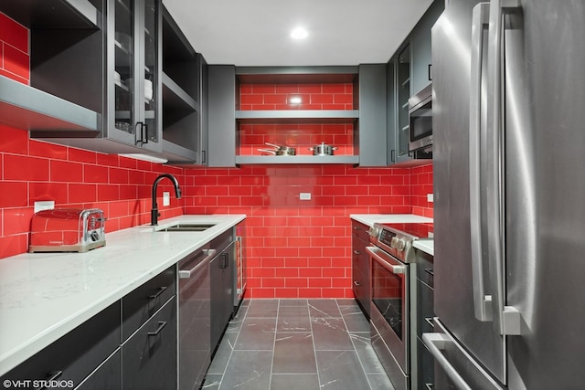 kitchen featuring a sink, stainless steel appliances, open shelves, and decorative backsplash