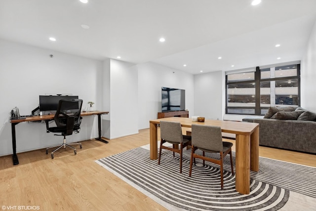 dining room with recessed lighting and light wood-style floors