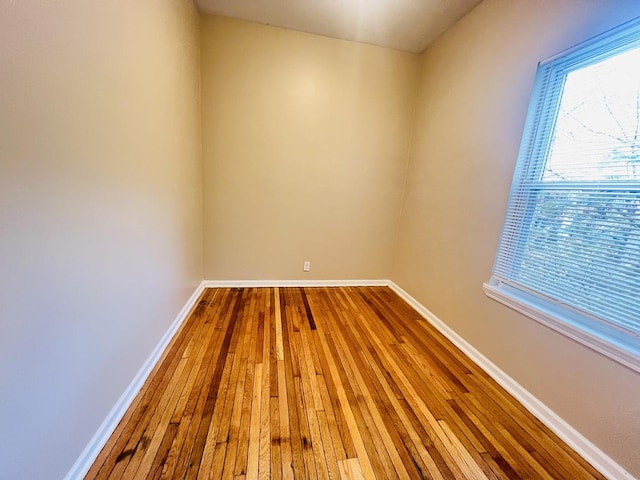 empty room featuring baseboards and wood finished floors