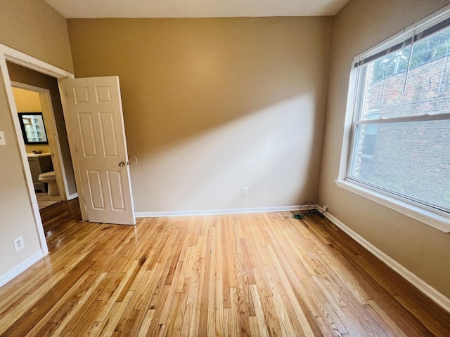 empty room with light wood-style floors and baseboards