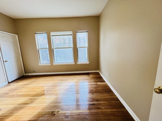 unfurnished bedroom with light wood-style floors and baseboards