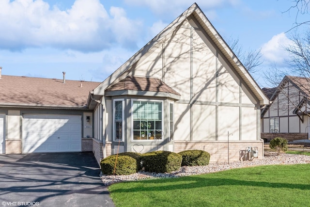 view of front of property featuring brick siding, aphalt driveway, roof with shingles, a front yard, and stucco siding