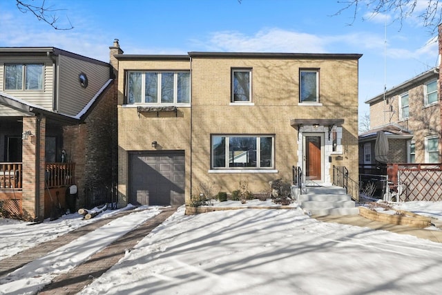 view of front of home with an attached garage, driveway, fence, and brick siding