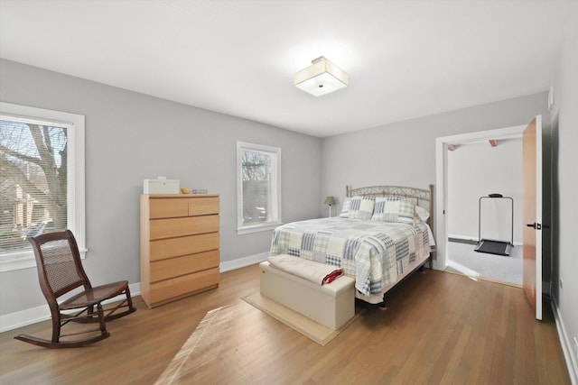 bedroom featuring baseboards and wood finished floors