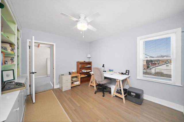 office space with ceiling fan, light wood-style flooring, and baseboards