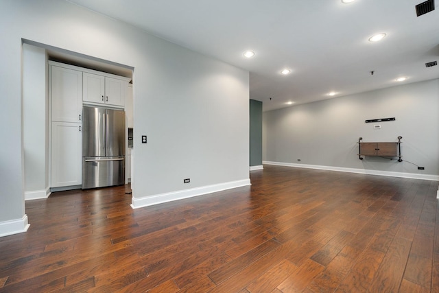 unfurnished living room featuring recessed lighting, visible vents, and dark wood-type flooring