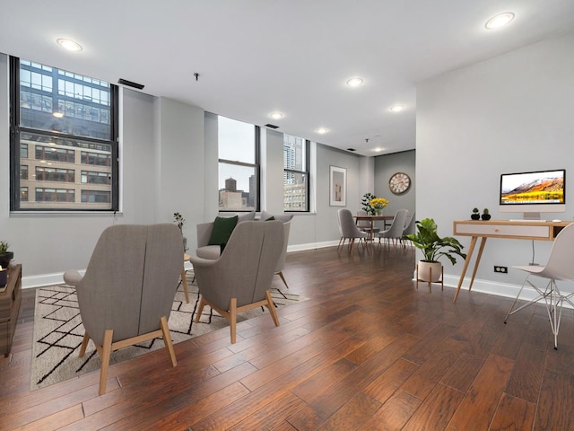 living area with recessed lighting, baseboards, and wood finished floors