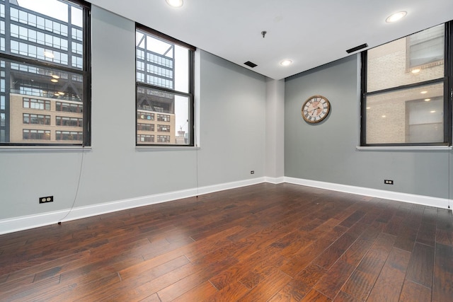 spare room with recessed lighting, baseboards, and hardwood / wood-style floors