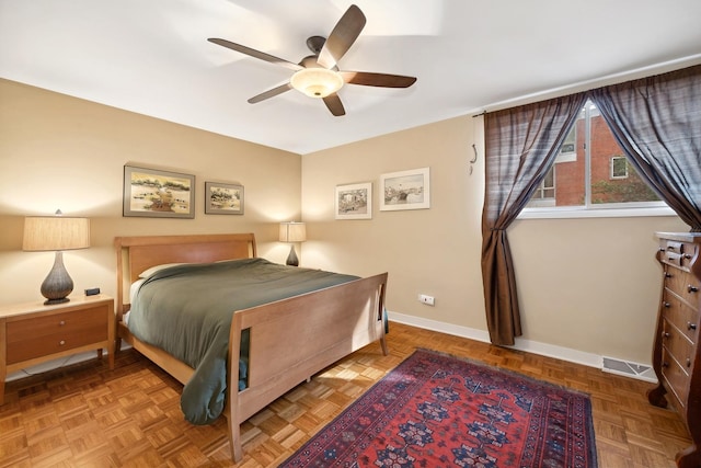 bedroom featuring a ceiling fan, visible vents, and baseboards