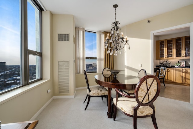 501 N Clinton St Unit 1705, Chicago, IL 60654 - dining room with healthy amount of natural light, a chandelier, and light colored carpet