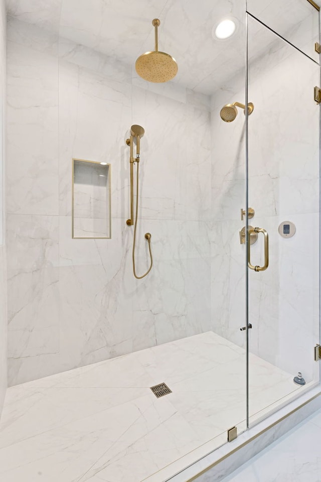 full bathroom featuring marble finish floor and a marble finish shower