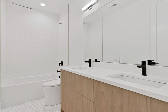 full bathroom featuring double vanity, shower / bath combination, toilet, and a sink